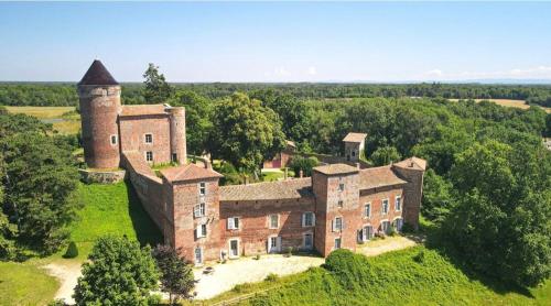an old castle with a tower on a hill at Château du Montellier in Le Montellier