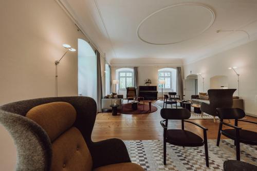 a living room with a couch and chairs at Hotel Kloster Fischingen in Fischingen