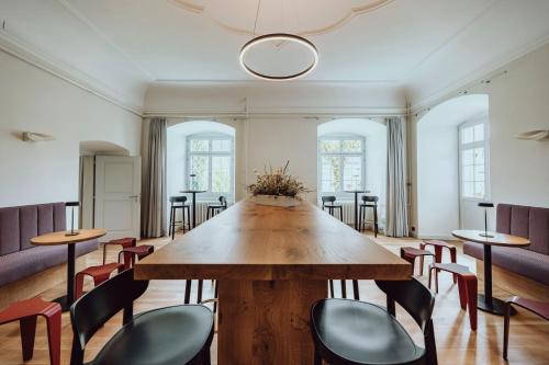 a large wooden table in a room with chairs at Hotel Kloster Fischingen in Fischingen