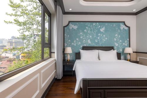 a bedroom with a bed and a large window at Sapa Soleil Hotel in Sa Pa