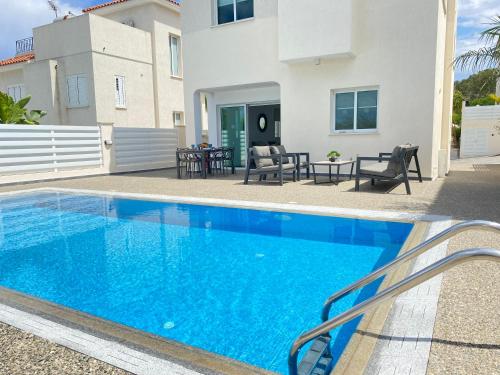 a swimming pool in front of a house at Casa de Nicole in Protaras