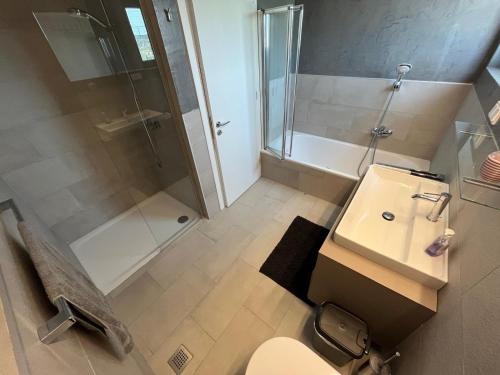 a bathroom with a shower and a toilet and a sink at Villa Milan 1 mit Padelplatz in Kos Town