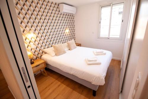 une chambre avec un lit avec deux serviettes dessus dans l'établissement Brand New Central Cannes Apt 2 min walk to Palais, à Cannes