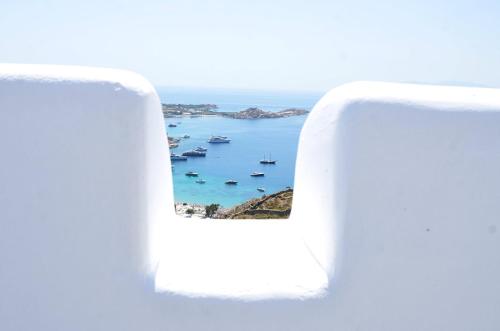 an open window with a view of the ocean at Villa Thelgo Mykonos in Psarou