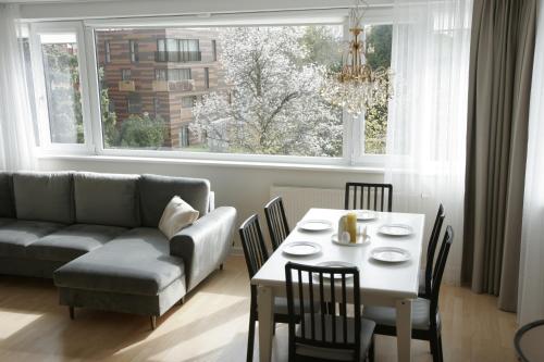 a living room with a couch and a table and a window at Saulene Apartments in Palanga