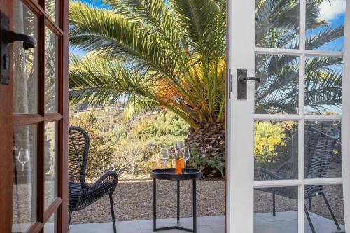 an open door to a patio with a table and chairs at Hill Moi Country stay by the Sea in Victor Harbor
