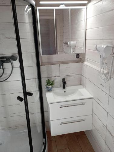 a bathroom with a sink and a mirror at Domki U Ali w Rewalu in Rewal