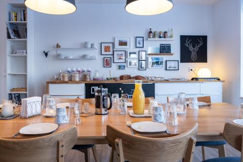 a wooden table with chairs and a long table with glasses at Wildact Adventure AB in Storberg