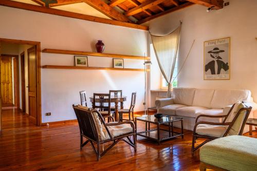 a living room with a couch and chairs and a table at Villa Giulia by MyVillaCollection in Lenno