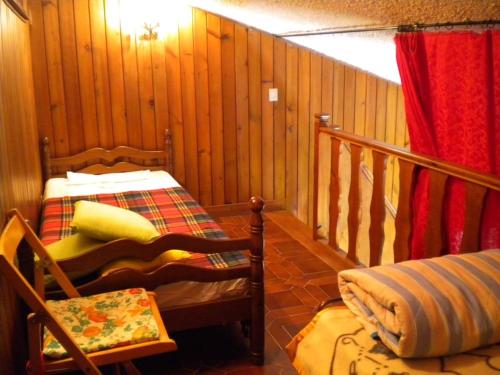 a room with wooden walls and a bed and a window at La Casa di Campo Staffi in Filettino Graziani