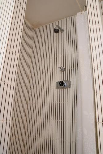 a shower with two shower heads in a bathroom at Villa Giulia by MyVillaCollection in Lenno