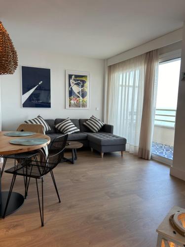 a living room with a couch and a table at Hotel Els Pins in Platja  d'Aro