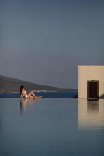 a woman sitting in the middle of a body of water at Doria Hotel Bodrum-City Center in Bitez