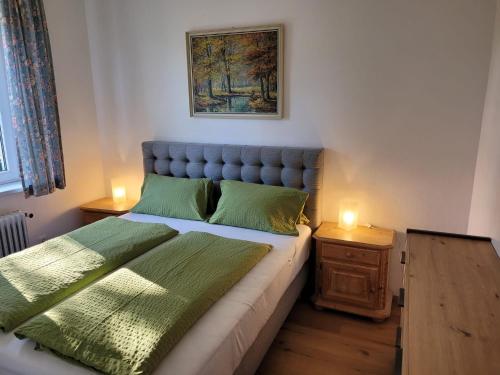 a bedroom with a bed and two lamps on tables at Landhaus Pension Jany in Bad Tatzmannsdorf