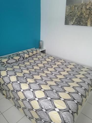 un lit avec un motif noir et blanc sur lui dans l'établissement Chambre proche du mont Saint Michel, à Montours