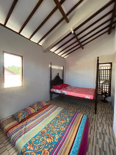 a bedroom with a large bed and a window at Gemyah in Glagah