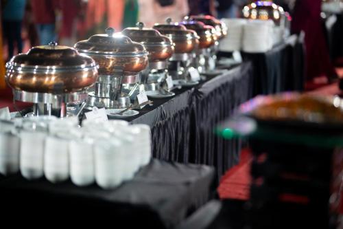 a row of pots and pans on a table at Sayaji Pune in Pune