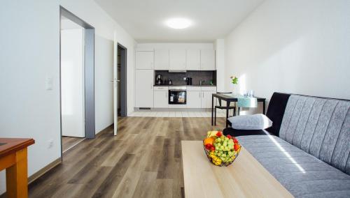 a living room with a couch and a table at MAGNET Boardinghouse in Schkeuditz