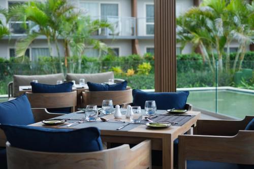 a wooden table with chairs and glasses on a patio at Crowne Plaza Fiji Nadi Bay Resort & Spa by IHG in Nadi