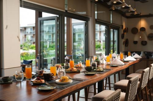 a long table in a restaurant with food and orange juice at Crowne Plaza Fiji Nadi Bay Resort & Spa by IHG in Nadi