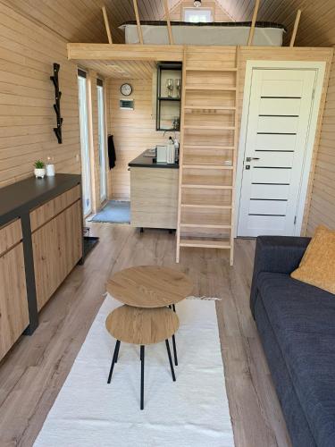 a living room with a couch and a table at Zbrusu nový luxusní Tiny House kousek od Moravského krasu in Hluboké