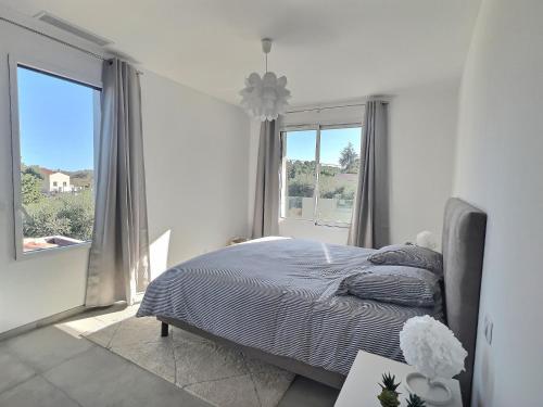 une chambre avec un lit et une grande fenêtre dans l'établissement Villa Mangenie, à Valbonne