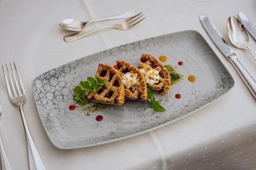 a plate of food with waffles on a table at Hotel Kloster Fischingen in Fischingen