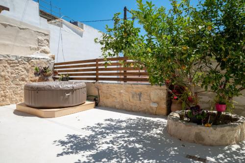 a large tub sitting next to a tree at Kalliope's house in Knossos in Knosos