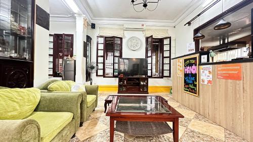 a living room with a couch and a coffee table at Tuna Homestay Hanoi & Experience in Hanoi
