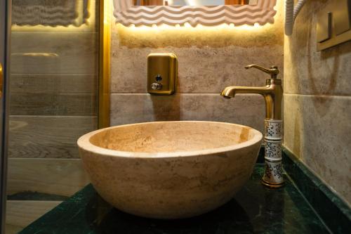 a stone sink in a bathroom with a shower at Mahhsen Mansion Oldcity in Istanbul