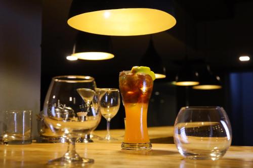 a group of wine glasses sitting on a table at Kfour Apartment & Hotels Private Limited in Madurai