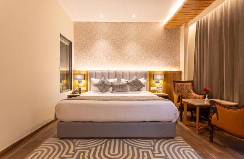 a hotel room with a bed and a desk at The Belvedere Himalayan Retreat, Mcleodganj, Dharamshala - By Leisure Hotels in McLeod Ganj