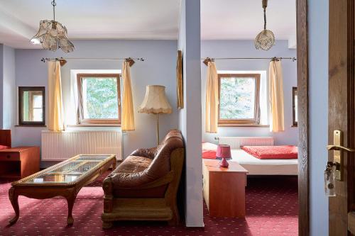 a living room with a couch and a bedroom at Jaś i Małgosia in Szklarska Poręba
