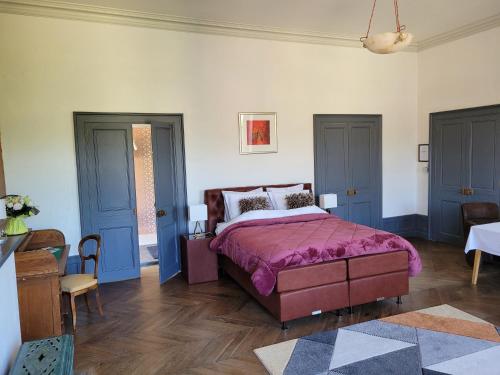 a bedroom with a bed with purple sheets and blue doors at Marraycourt, Chateau-Chambre d'Hotes in Marcigny