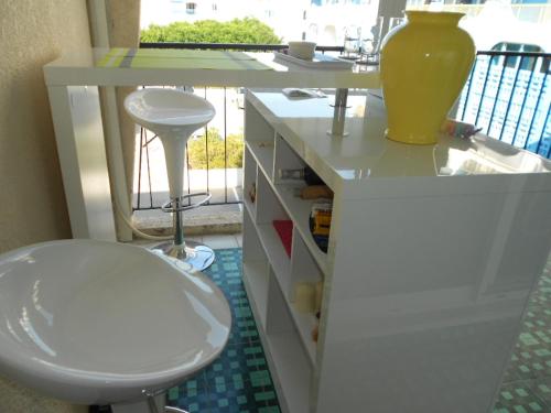 a bathroom with a white sink and a toilet at Isis in La Grande-Motte