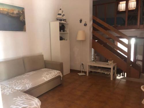 a living room with a bed and a staircase at Villa sul mare in Bisceglie