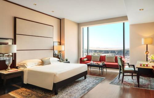 a hotel room with a bed and a couch at Taj Bangalore in Devanahalli-Bangalore