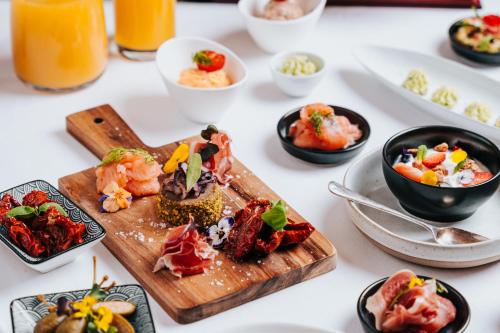 a table with plates of food on it at Hotel Kaštieľ Mojmírovce in Mojmírovce