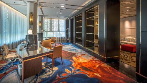 an office with a desk and chairs in a room at InterContinental Dhaka by IHG in Dhaka