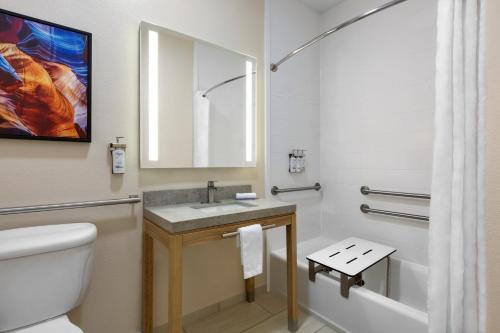 a bathroom with a sink and a toilet and a mirror at Candlewood Suites Vicksburg by IHG in Vicksburg