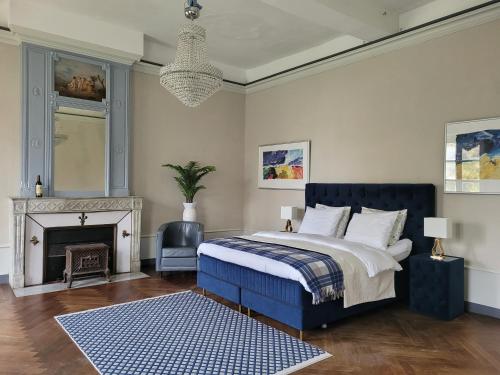 a bedroom with a king sized bed and a fireplace at Marraycourt, Chateau-Chambre d'Hotes in Marcigny