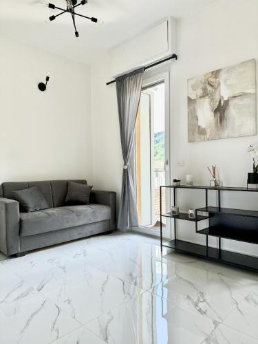 a white living room with a couch and a table at casa la Rosa in Lesa