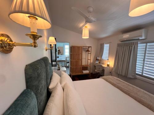 a bedroom with a bed and a living room at Floriana Boutique Hotel in Cairns