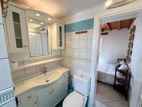 a bathroom with a toilet and a sink and a mirror at Classy Classic in Mýkonos City