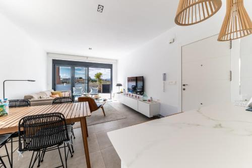 a living room with a table and chairs at Villa Armonia - Heated Pool - Countryside Charm - by OYOOSTAYS in Daya Nueva