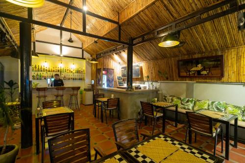 um restaurante com mesas e cadeiras e um bar em River Retreat Boutique Hotel em Siem Reap