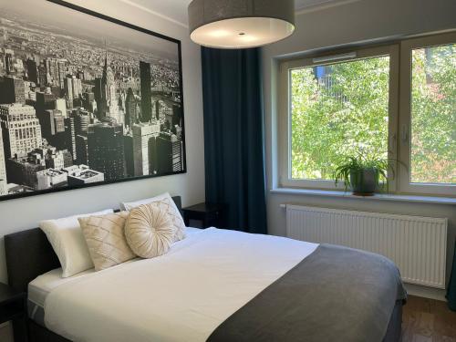 a bedroom with a bed and a large window at River View Old Town in Gdańsk