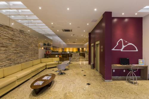 a lobby with couches and a brick wall at Pompeu Rio Hotel in Rio de Janeiro