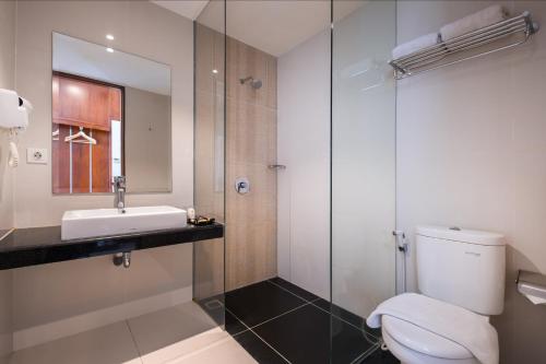 a bathroom with a toilet and a sink and a shower at Gets Premiere Semarang in Semarang