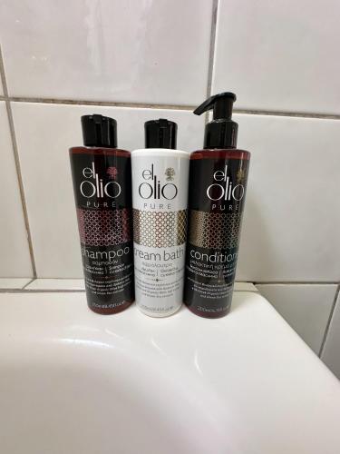 three deodorant bottles sitting on top of a sink at Classy Classic in Mýkonos City